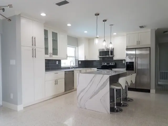 White shaker kitchen with a marble island