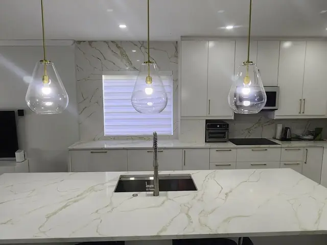 Marble island with gold pendant lights