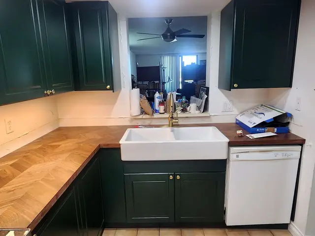 Green kitchen with butcher block counters