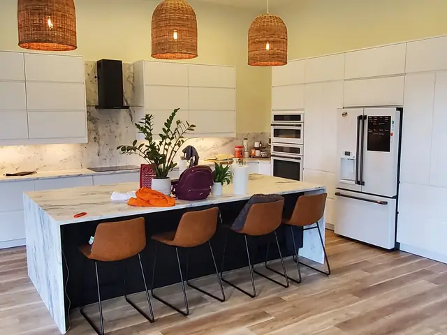 Marble waterfall island with leather stools