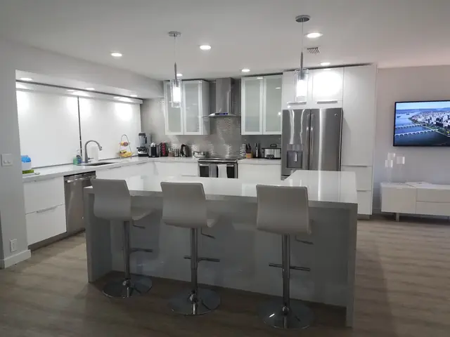 White kitchen with a gray waterfall island