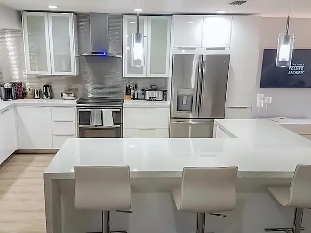 White kitchen with a large quartz island