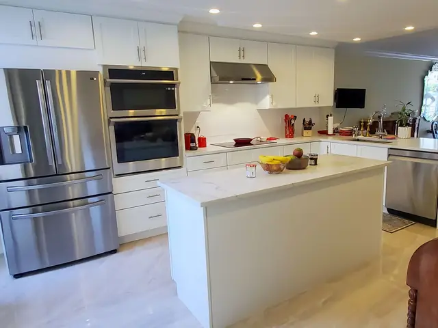 White kitchen with an island and tall cabinets