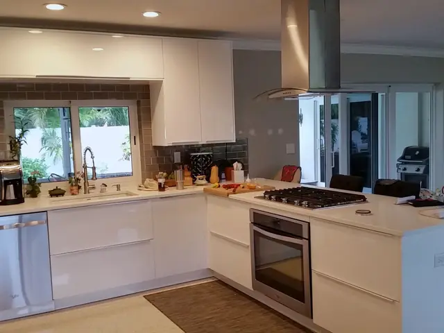 White kitchen with a stainless hood