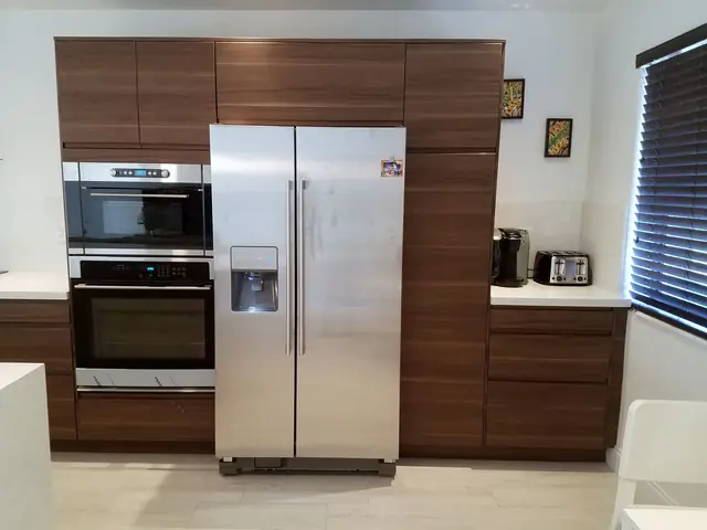 Walnut tall cabinets with built-in ovens