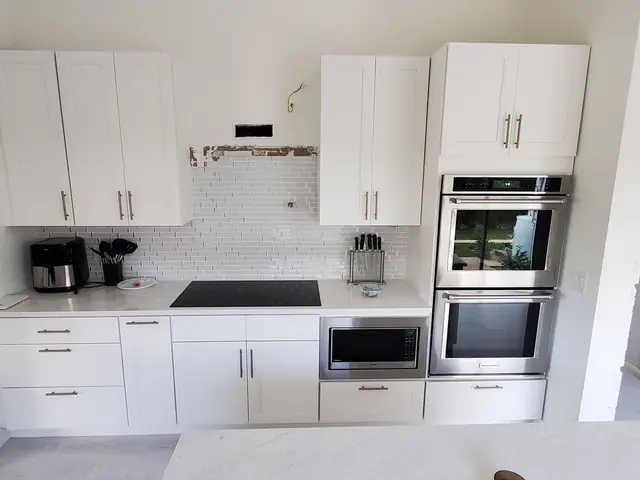 White shaker kitchen with double wall ovens